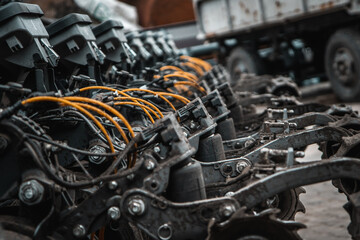 Fototapeta premium Agricultural Machinery. Close-up view of agricultural machinery components, focusing on the mechanical parts and hydraulic systems.