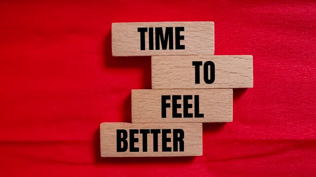 Time to feel better message writing on wooden blocks on red background. Conceptual time to feel better symbol.