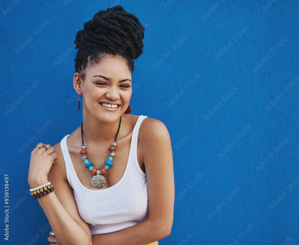 Wall mural Portrait, dreadlocks or black woman with fashion, mockup space or smile in studio on blue background. Cool stylist, happy hairdresser or proud African model with confidence, necklace or natural hair