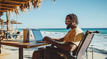 Man working on laptop at tropical beach. Remote work and digital nomad lifestyle concept in a beautiful sunny scenery.