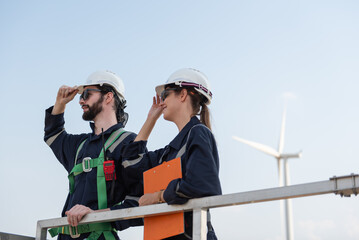 Engineers working on site in wind turbine farm, Wind turbines generate clean energy source, Eco technology for electric, industry environment