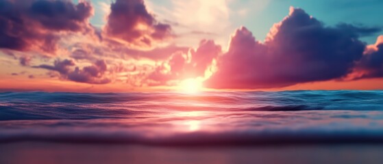 A breathtaking sunset over a calm ocean, blending vibrant colors of pink and orange, creating a serene atmosphere at dusk.