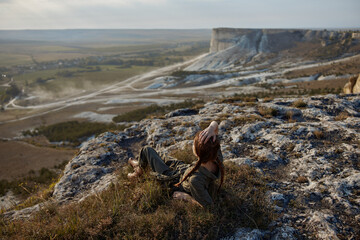 Woman contemplating the majestic valley and mountain range during a travel adventure