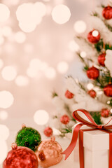 Christmas scene with a decorated tree, colorful ornaments, and a gift box with a ribbon. 3d rendering