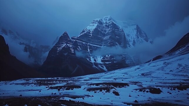Snowy kailash parvat mountain peaks rise into dramatic blue sky
