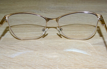 Eye glasses on a wooden background