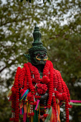 thai statue with offerings