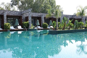 Outdoor swimming pool with clear water at luxury resort