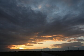 Beautiful cloudy sky over highway on sunset