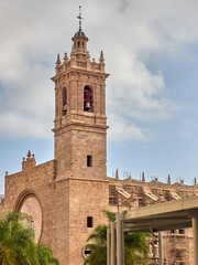 Bell tower and sundial in the covered rose window (O of San Juan) of the west facade of the Church of Los Santos Juanes. Valencia, Spain. Europe. July 2024.