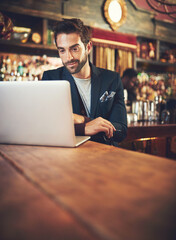 Obraz premium Bar, business and man with laptop, relax and connection with research, writer and technology. Restaurant, author and website info with computer, professional or internet with creativity or reading