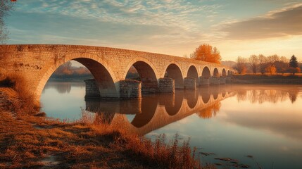 Historic medieval bridge, captured in a minimalist style with soft, natural lighting and a clear sky.