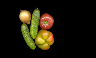 still life of vegetables on a black background (cucumbers, tomato, onion and pepper)