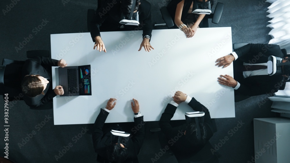Poster Top down aerial view of professional business team wear vr headset to enter virtual world while sitting and using hand gestures to manipulate the data from the manager laptop. Technology. Directorate.