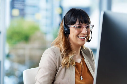 Business woman, computer and call center advisor with customer support and headphones at job. Office, smile and telemarketing consultant with web advice and help desk assistance with online agent