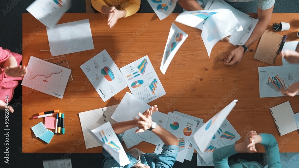 Poster top down view of smart business team holding paper and throw paper in the air to celebrate successfu