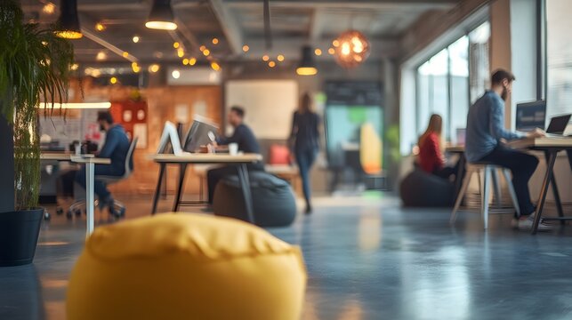 A modern office space with professionals working collaboratively, featuring a bright ambiance and casual seating arrangements, ideal for showcasing creative work environments in stock photography. 