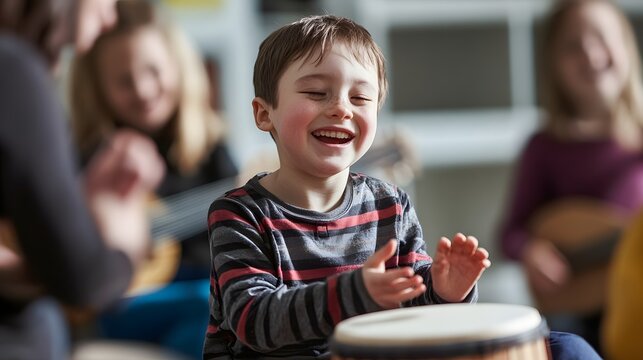 A joyful young boy plays the djembe drum in a vibrant music class with other children enjoying the experience. 