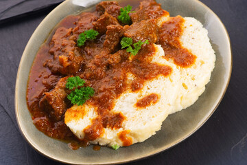 Beef goulash and dumplings (knedliky) on table