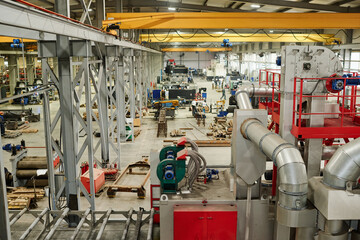Industrial warehouse filled with advanced machinery and equipment for manufacturing processes,...
