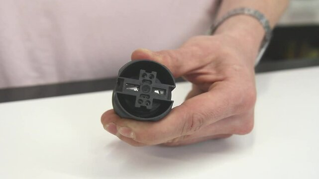 Demonstration of disassembling an E27 socket, step-by-step guide, electrical component maintenance, DIY electrical repair, hands-on tutorial