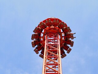 People free falling from tower ride at amusement park. Free Fall Tower in the amusement park.