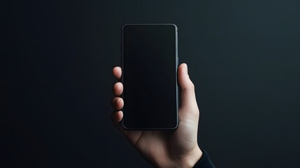Hand holding a smartphone with a dark screen against a black background