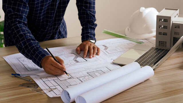 Engineer Drawing Architecture Plan And Construction Design. Design and build a new residential building - Real estate concept.