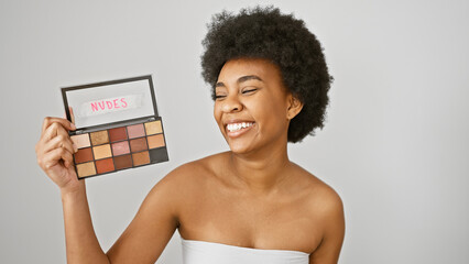 Smiling african american woman holding eyeshadow palette isolated on white background