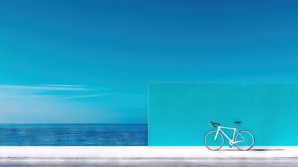   White bicycle beside blue wall, water nearby, blue sky backdrop