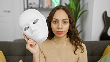 An intriguing portrait of a young woman holding a white mask, exuding mystery in a cozy living room...