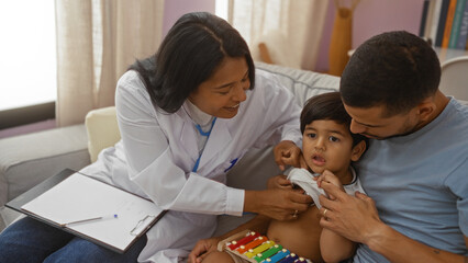 Obraz premium Pediatrician examines child with father at home while latino woman doctor smiles, indoor house visit scene.