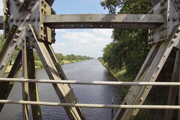 Naklejka premium View from the Ehzerbrug, Dutch traffic bridge (truss bridge) on the canal (Twentekanaal) near Almen in Gelderland. Netherlands, Summer, August