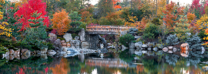 Panoramic view of walking bridge in scenic Frederik Meijer gardens in autumn time in Grand Rapids, Michigan.