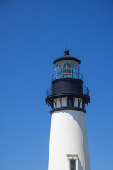 Yaquina Head Lighthouse against blue sky, in Oregon state, USA.