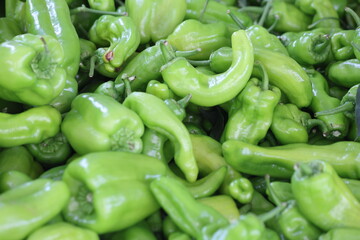 close up of green peppers on market