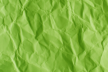 Crumpled green paper texture background. Wrinkled paper surface abstract background.
