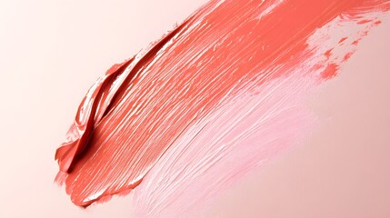 A vibrant brushstroke of coral and soft pink paint on a textured surface, ideal for artistic and creative projects. 