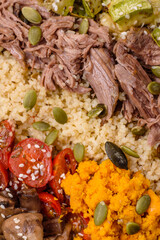 Bowl of food with beef, bulgur, tomatoes, mushrooms, zucchini