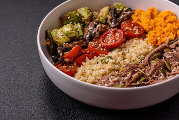 Bowl of food with beef, bulgur, tomatoes, mushrooms, zucchini