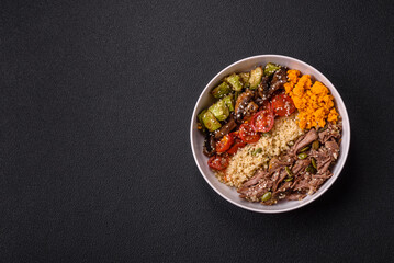 Bowl of food with beef, bulgur, tomatoes, mushrooms, zucchini