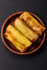 Homemade fried pancakes with filling on a ceramic plate