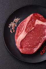 Fresh, raw beef steak with salt, spices and herbs