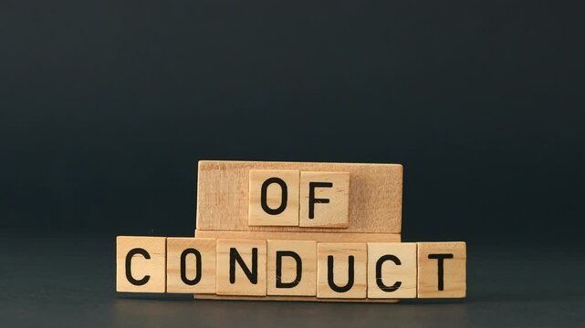 Business and code of conduct concept, businessman's hand sets wooden blocks with words Code of conduct.  Code of conduct symbol. beautiful navy blue background. Copy space