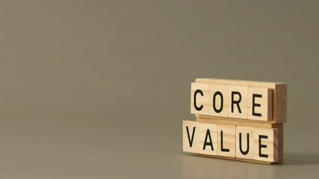 Our Core Values ​​Symbol. Concept words Our Core Values ​​set by businessman hand on wooden blocks. Beautiful gray background. Business and Our Core Values ​​concept. Copy space
