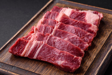 Fresh raw beef cut into slices with salt, spices