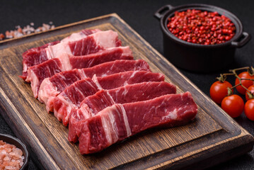 Fresh raw beef cut into slices with salt, spices