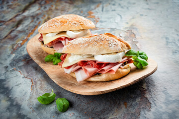 Traditional New Orleans muffaletta sandwiches with mortadella, salami and provolone cheese served...