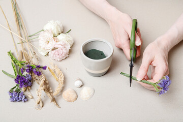 Florist at work: How to make simple floral arrangement with eustoma and limonium. Step by step,...