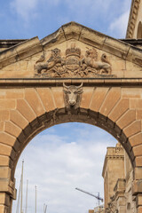 Malta, between Senglea and Birgu, carving on Royal Navy Victualling Yard gate. British Royal Coat of Arms. And a cow's head.